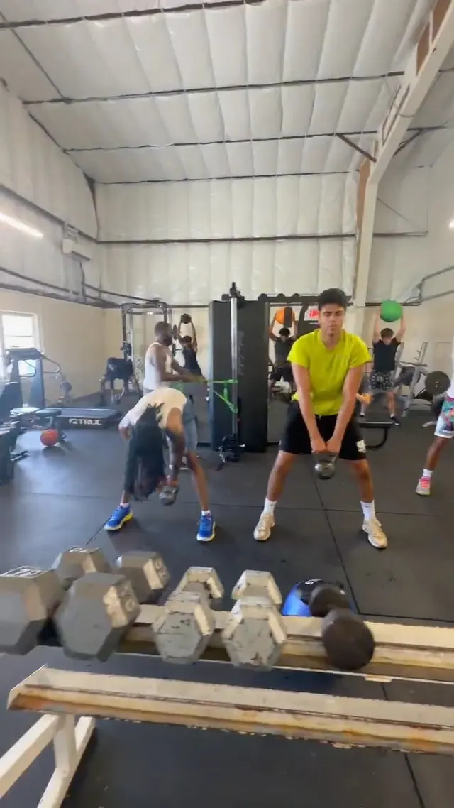 Group of athletes doing kettlebell swings together