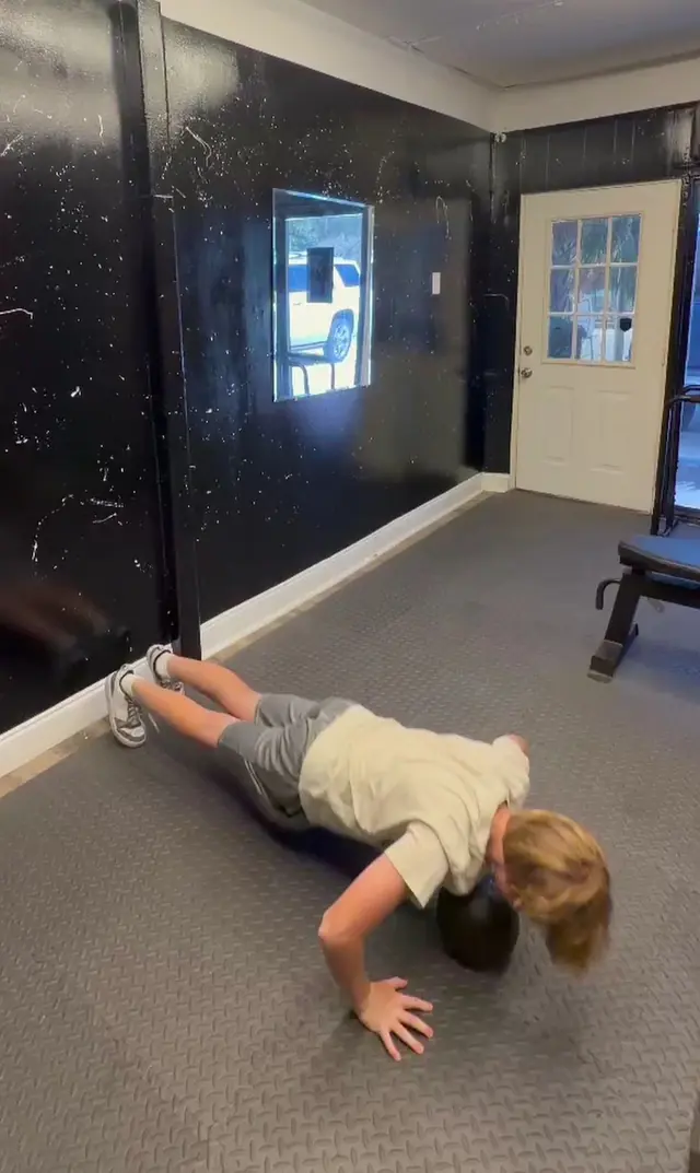 Young athlete doing a medicine ball push-up